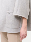 close up of a gray poncho with pocket #color_dawn-blue