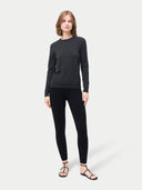 front view of a woman wearing a dark gray sweater and black leggings on a white background #color_black