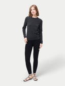Woman wearing a dark gray sweater and black leggings on a white background #color_black