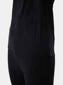 close up bottom side of a black wrinkled t-shirt and pants #color_black