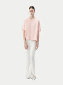 front view of a pink cashmere t-shirt and white pants #color_primrose-pink