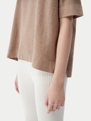 close up bottom side of a brown top and white ribbed pants #color_timber-wolf