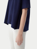 close up of a navy cashmere t-shirt with white pants #color_navy