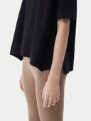 close up of a black cashmere t-shirt and brown ribbed pants #color_black