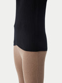 close up of a black top and brown pants #color_black
