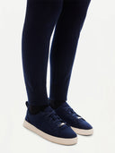 close up of navy jogger pants matching cashmere sneakers on a light gray background #color_navy