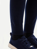 close up of navy jogger and matching navy sneakers with black socks on a light gray background #color_navy