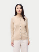 close up front view of a woman wearing a beige cardigan against a white background #color_beige
