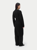 back view of a long black dress on a plain background #color_black