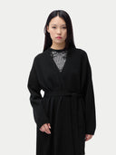 Woman wearing a black robe and a silver top on a white background #color_black