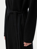 Black robe worn by a person on a white background #color_black