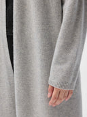 Close-up of a gray cardigan and sweater on a person. #color_dawn-blue
