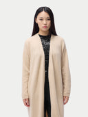 Woman wearing a beige long cardigan on a plain background #color_beige