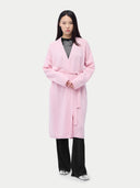 Person wearing a pink robe on a plain background #color_almond-blossom