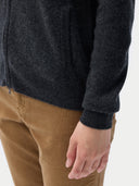 close up of a Dark gray zip-up hoodie and brown pants on a white background #color_charcoal