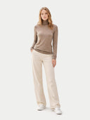 front view of a woman wearing a brown turtleneck sweater and beige pants on a white background #color_taupe
