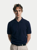 Close-up shot of Man wearing a navy blue polo shirt against a white background #color_mood-indigo