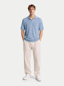 front view of a light blue polo shirt and beige pants on a white background #color_celestial-blue