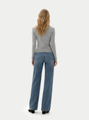 back view of a woman wearing a gray long-sleeve sweater and blue jeans on a white background #color_high-rise