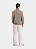 back view of a Person wearing a brown sweater and white pants on a white background #color_taupe