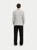 back view of a checkered blazer and black pants on a white background #color_off-white