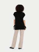 back view of a black sleeveless top and beige pants on a white background #color_black