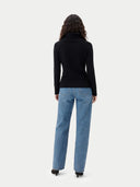 back view of a person wearing a black turtleneck and blue jeans on a white background #color_black