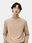 close up front view of Man wearing a beige turtleneck sweater against a white background #color_warm-grey