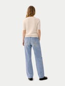 back view of a beige sweater and light blue jeans on a white background #color_off-white