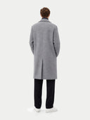 back view of a person wearing a gray overcoat on a white background #color_dim-gray