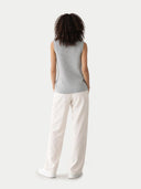 Back view of person wearing a gray sleeveless top and white pants on a light gray background #color_high-rise