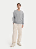 front view of a Man wearing a gray sweater and beige pants on a white background #color_vapor-blue