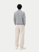 back view of a Person wearing a gray sweater and white pants on a white background #color_vapor-blue