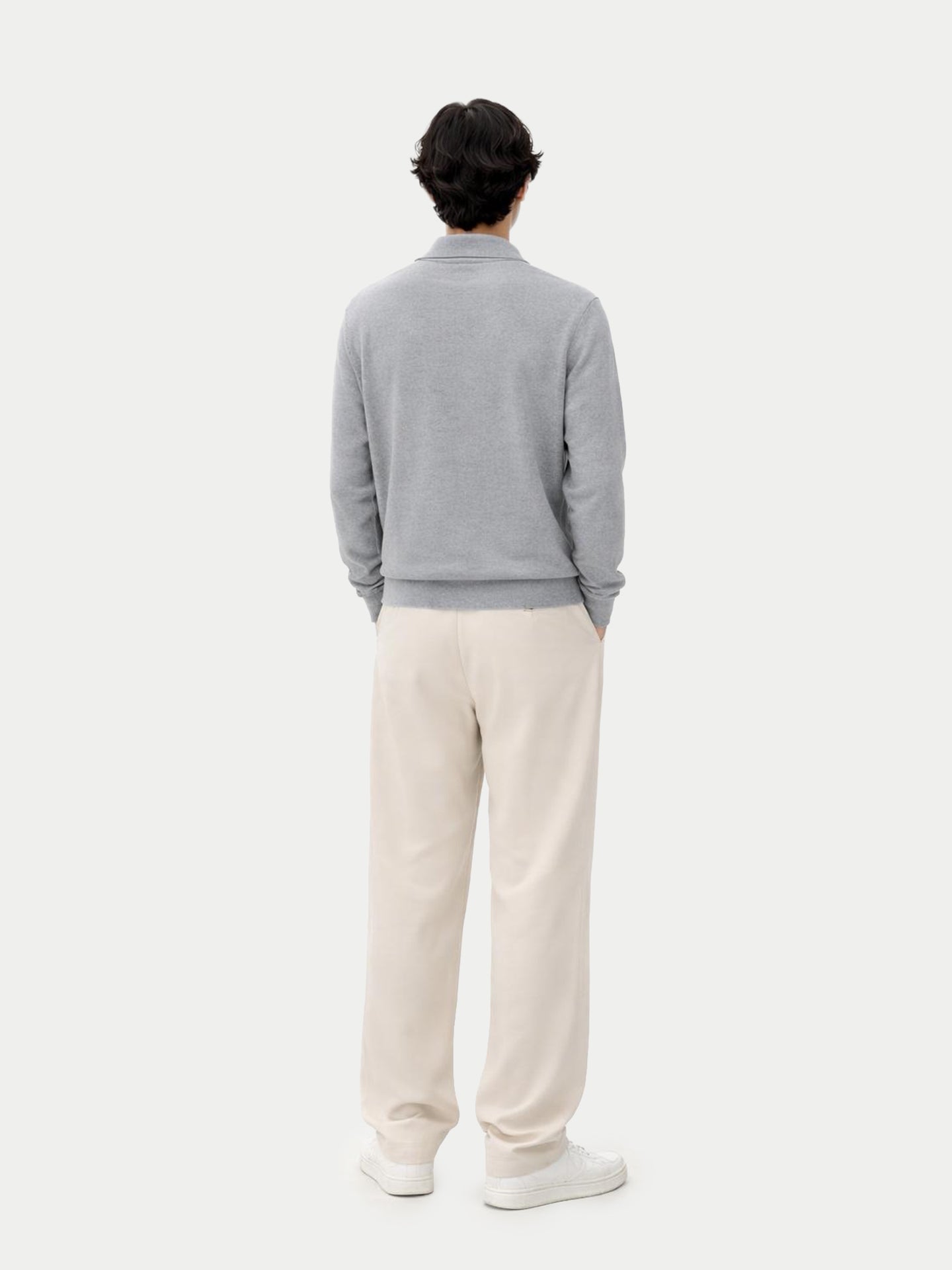 Person wearing a gray sweater and white pants on a white background #color_vapor-blue