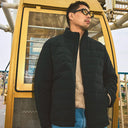 Man wearing black cashmere quilted jacket over beige sweater — @GobiCashmere
