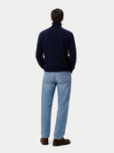 front view of a man wearing a navy sweater and light blue pants on a white background #color_navy-blazer