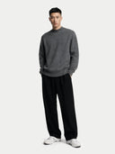 front view of a man wearing a gray sweater and black pants on a white background #color_plum-kitten