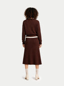 back view of a person wearing a brown sweater and skirt set on a white background #color_deep-mahogany