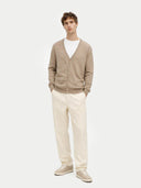 front view of a Man wearing a beige v-neck cardigan, white shirt, and cream pants on a white background #color_taupe