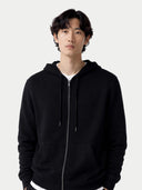 The photo has been enlarged. Person wearing a black hoodie against a white background #color_black