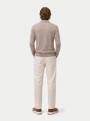 back view of a man wearing a beige sweater with a collar and white pants on a white background #color_timber-wolf