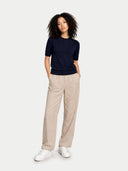front view of a woman wearing a navy short sleeve sweater and beige pants on a white background #color_navy-blazer