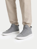 Gray high-top sneakers worn with beige pants on a white background  #color_stone-gray