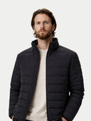 Man wearing a black puffer jacket on a white background #color_black