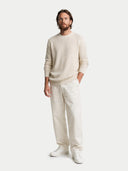 Man wearing a beige sweater and pants on a white background #color_off-white