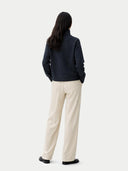back view of a navy sweater and beige pants on a white background #color_charcoal