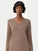 Woman wearing a brown v-neck sweater on a white background #color_taupe