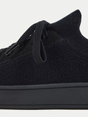 Close-up of a black sneaker with a white background