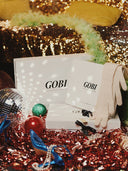 Gobi product packaging with festive decorations on a glittery background. mobile
