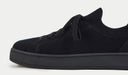 Black sneaker on a light gray background